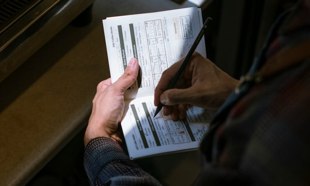person holding white printer paper