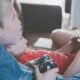 Two children playing video games together with controllers indoors.