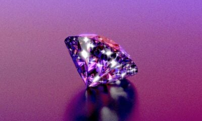 A sparkly diamond shines on a purple background.