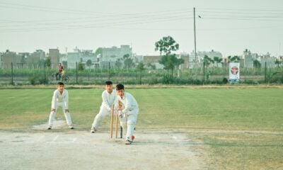 a group of men playing a game of cricket