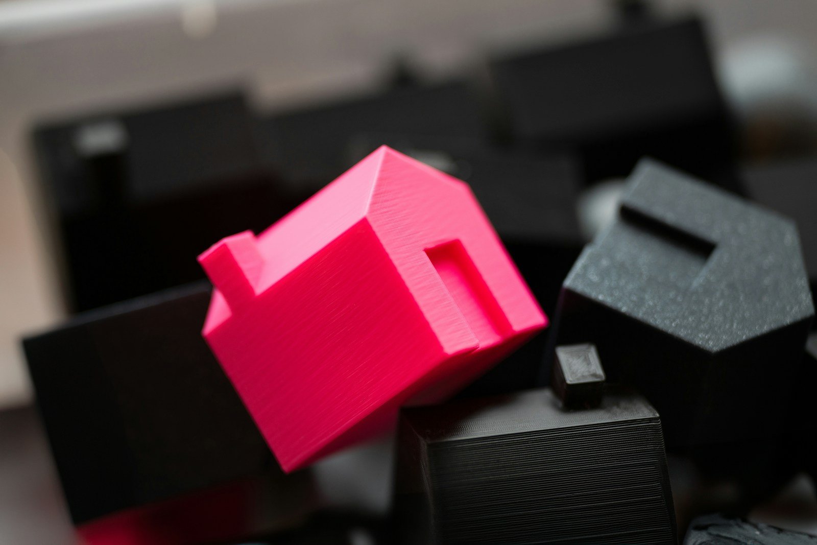 Why Home Buyers Can't Find Your Custom Builds (It's Not What You Think) 16 A group of black and pink objects sitting on top of a table