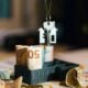 A house hanging from a string on top of a pile of money