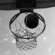 a black and white photo of a basketball going through the hoop