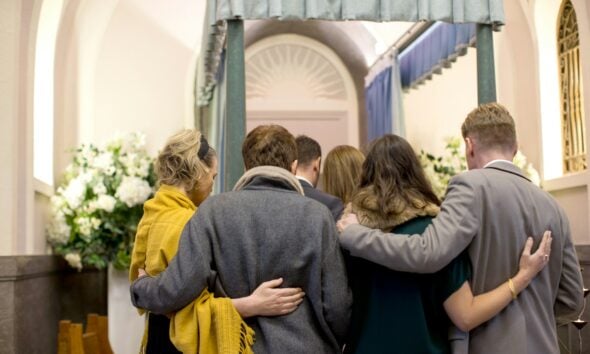 a group of people standing in front of a doorway
