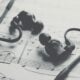 black earbuds on white paper