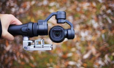 person holding black tripod with camera