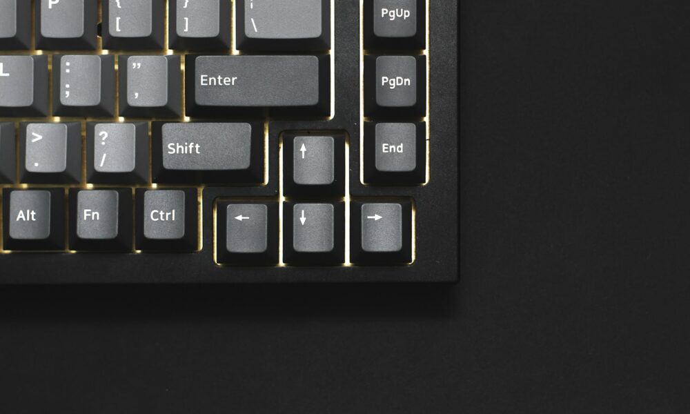 a close up of a keyboard on a black surface