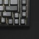 a close up of a keyboard on a black surface