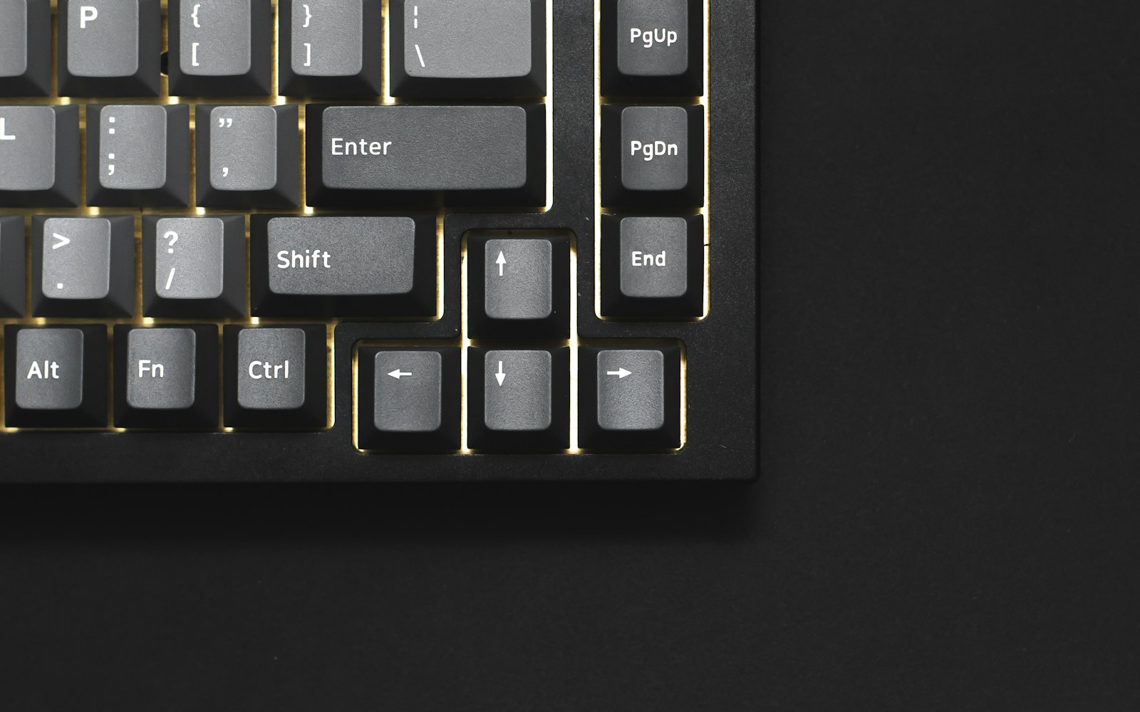a close up of a keyboard on a black surface