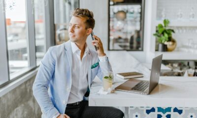 man sitting beside white wooden table