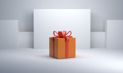 an orange gift box with a red bow