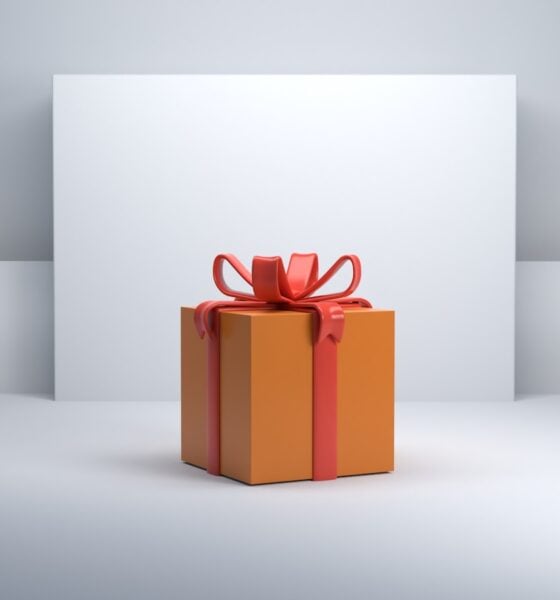 an orange gift box with a red bow