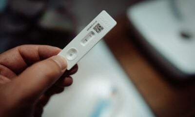a person holding a wii remote control in their hand