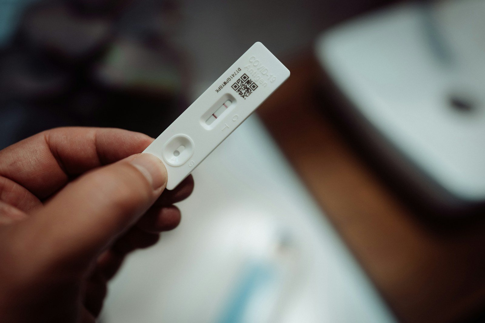 Challenging the Accuracy of Home Pregnancy Tests 16 a person holding a wii remote control in their hand