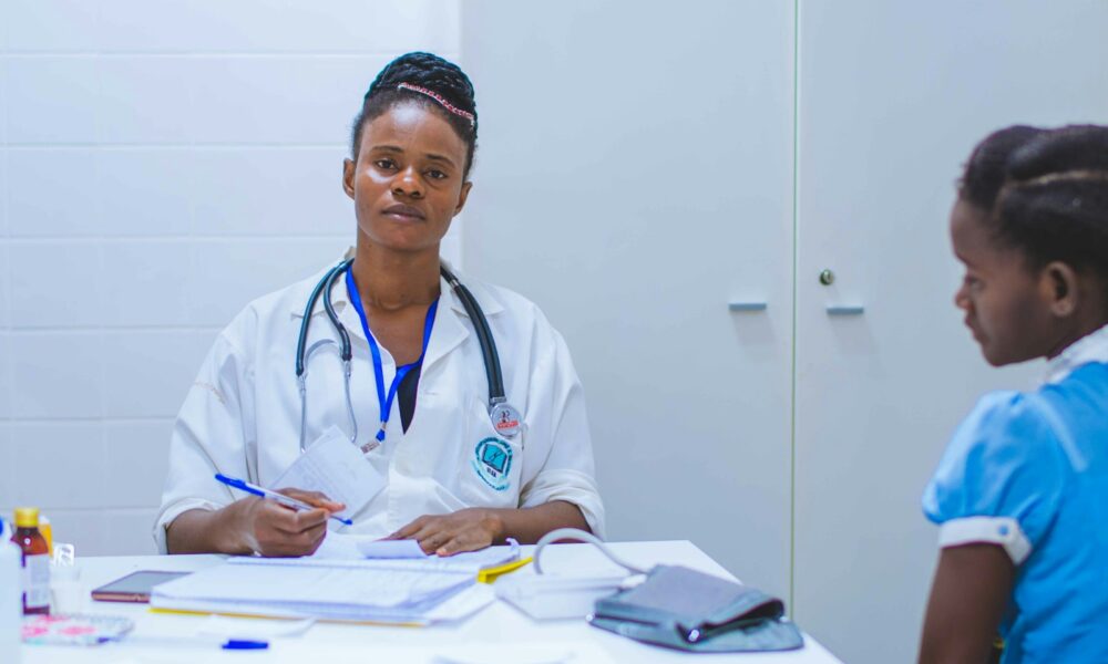 doctor sitting at the table in front of girl