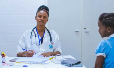 doctor sitting at the table in front of girl