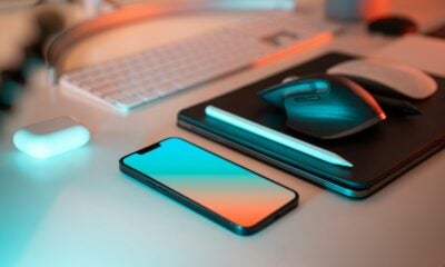 a laptop, mouse, and cell phone on a desk