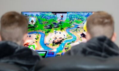 two boys are playing a video game on the television