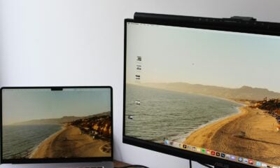 a laptop computer sitting on top of a desk next to a monitor