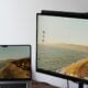 a laptop computer sitting on top of a desk next to a monitor