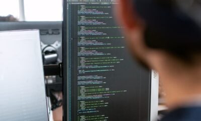 man in black shirt sitting in front of computer monitor