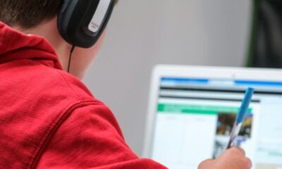 person in red shirt wearing black and gray headphones