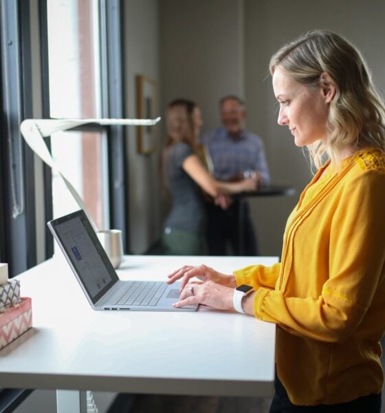 woman in yellow long sleeve shirt using macbook pro