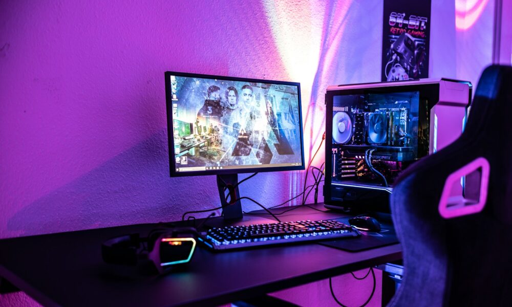 a desk with a computer and a gaming chair