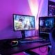 a desk with a computer and a gaming chair