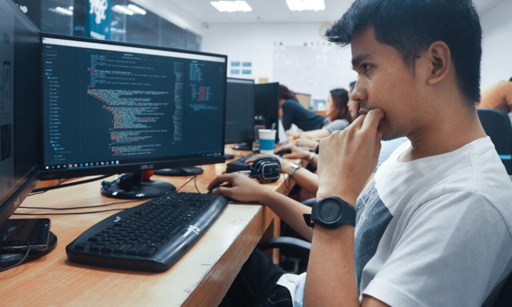 person holding a computer mouse in a room