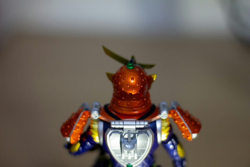 A figurine of a robot holding a shield