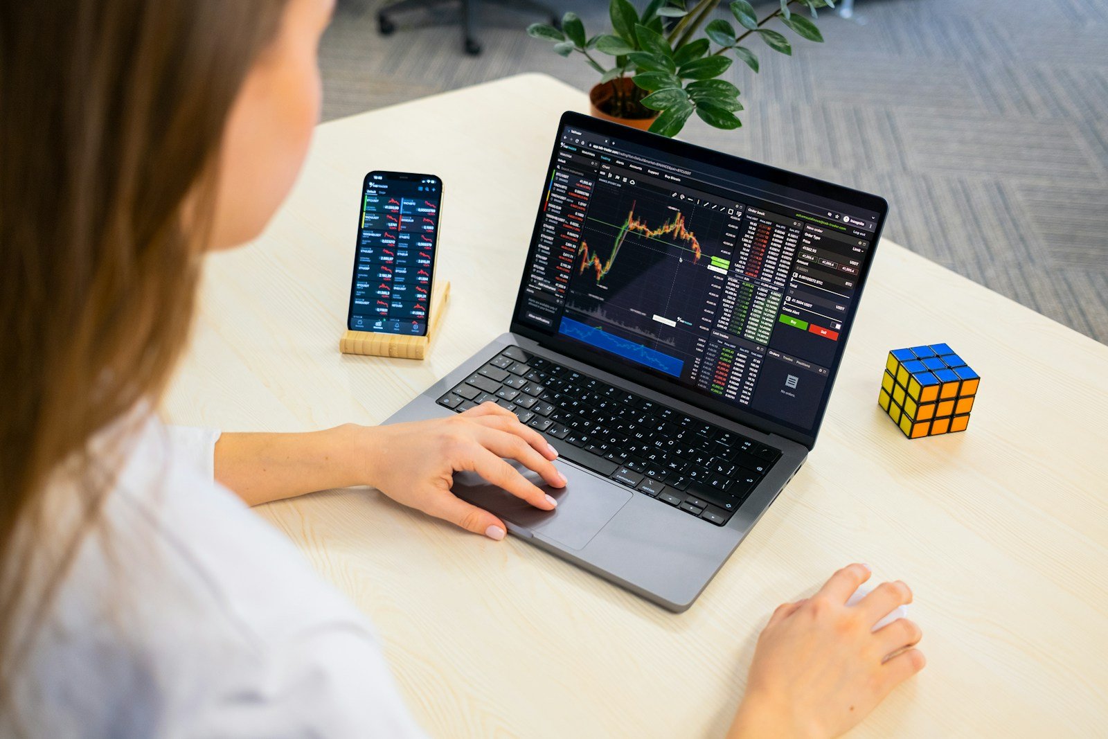From Beginner to Pro: How to Start with Cryptocurrency in Finland — Insights from Kryptot.fi 16 a woman sitting at a table using a laptop computer
