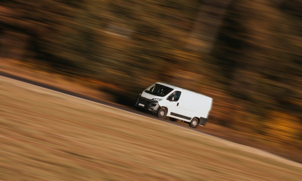 a white car driving on a road