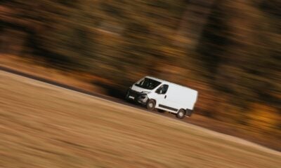 a white car driving on a road