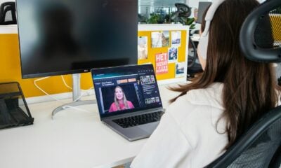 a woman sitting in front of a computer monitor