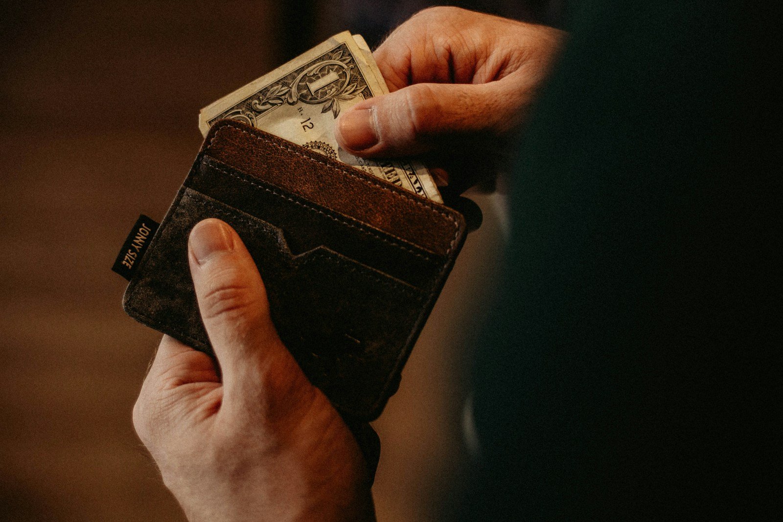 Understanding Bad Debts Journal Entry Practices 16 person getting 1 U.S. dollar banknote in wallet