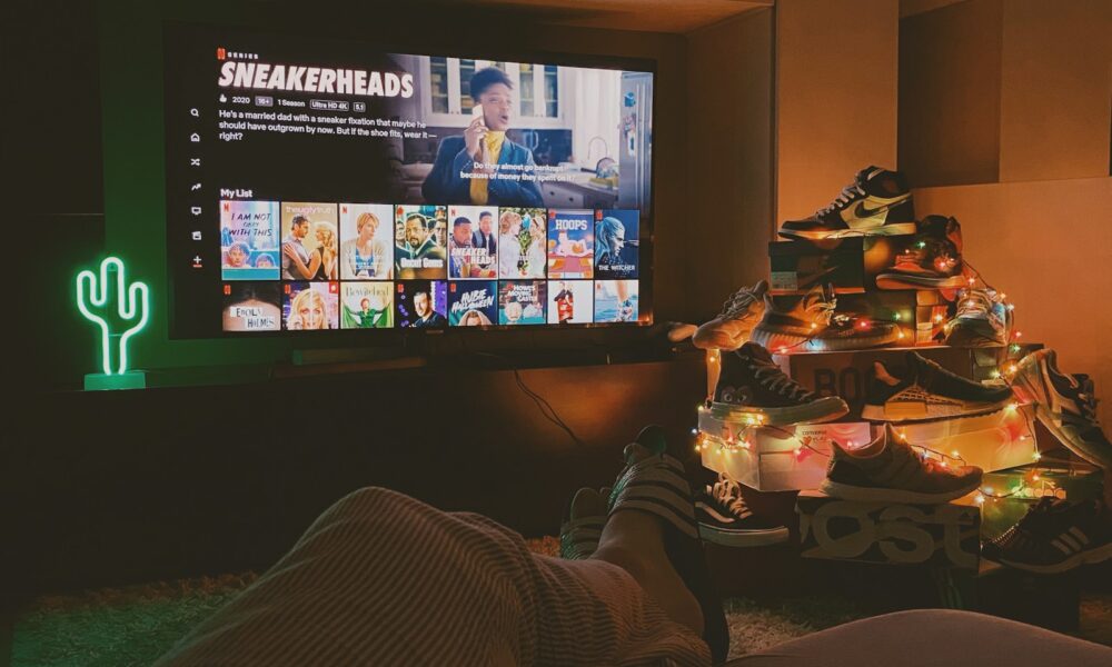 black flat screen tv turned on displaying man in black suit
