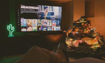 black flat screen tv turned on displaying man in black suit