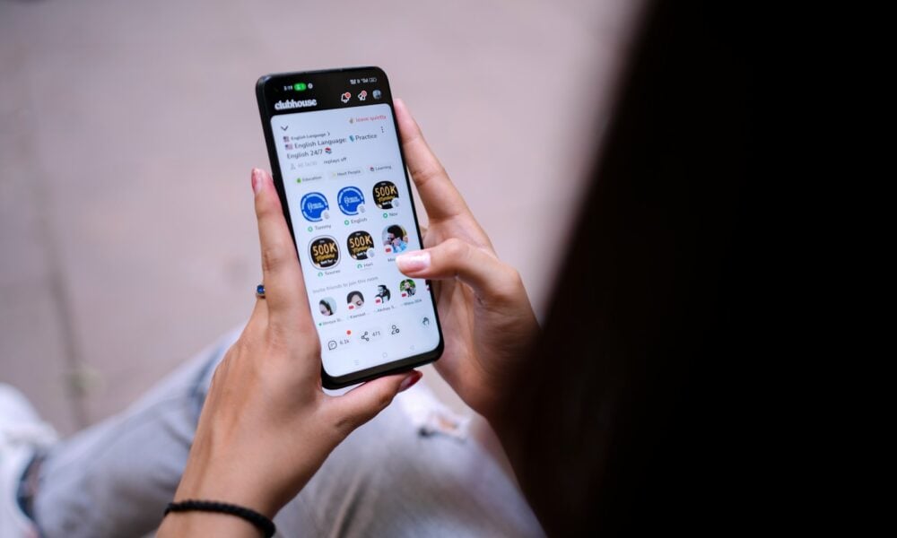 a person holding a cell phone in their hand