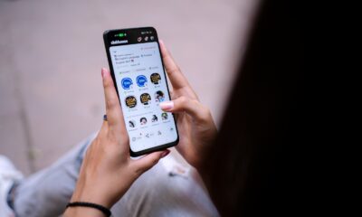 a person holding a cell phone in their hand