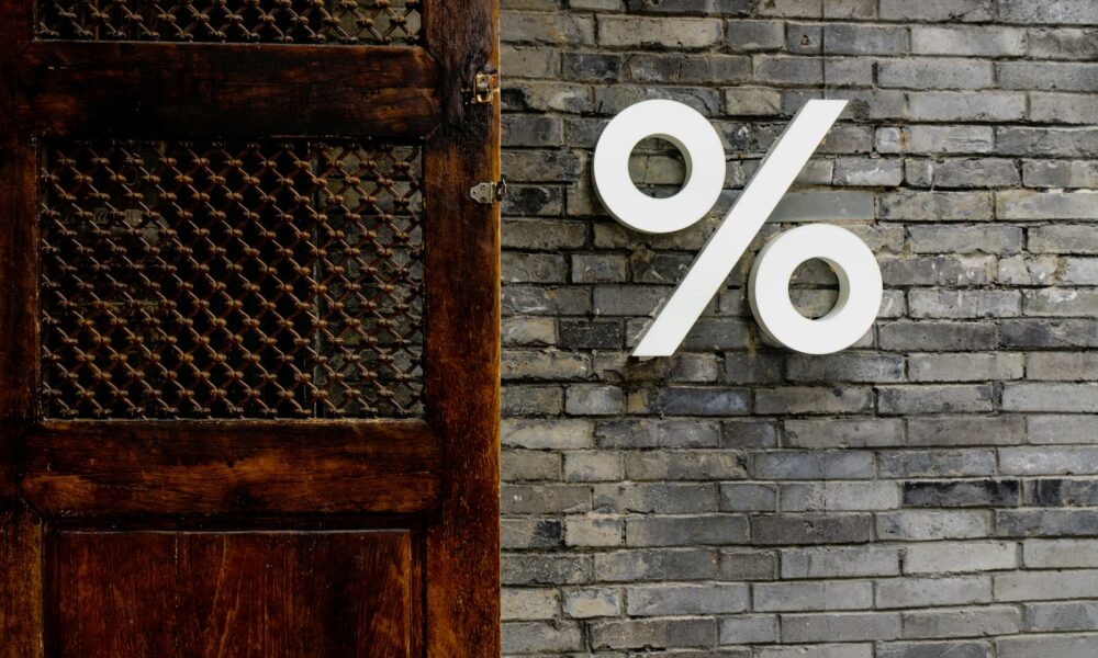 White percentage sign on a brick wall