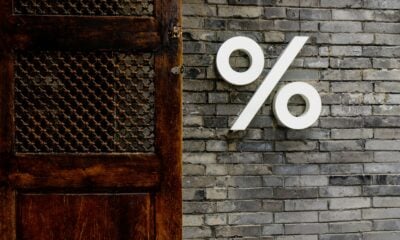 White percentage sign on a brick wall