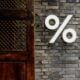 White percentage sign on a brick wall