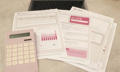 Bills, calculator, and a laptop: financial tasks underway.