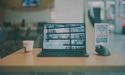 a laptop computer sitting on top of a wooden table