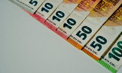 a row of ten hundred dollar bills sitting on top of a table