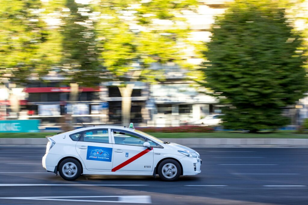 white sedan on road during daytime