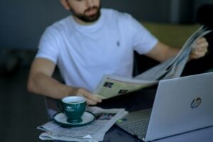 Discover Kongotech org - Your Ultimate Tech and Innovation Hub 17 a man sitting at a table reading a newspaper