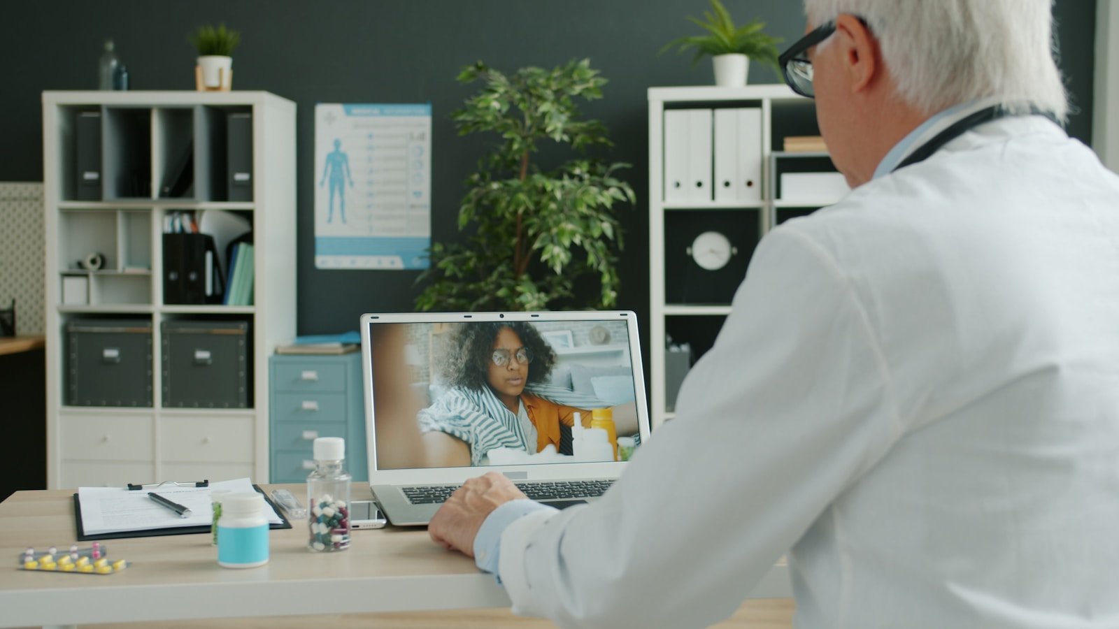 Doctor consults with patient via video call.