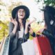 Two women with shopping bags in a park